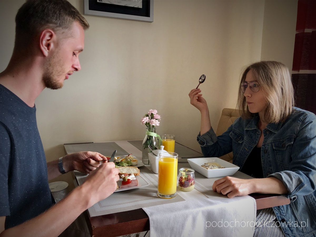 Para je śniadanie przy stole w Rezydencji Pod Ochorowiczówką B&B w Wiśle